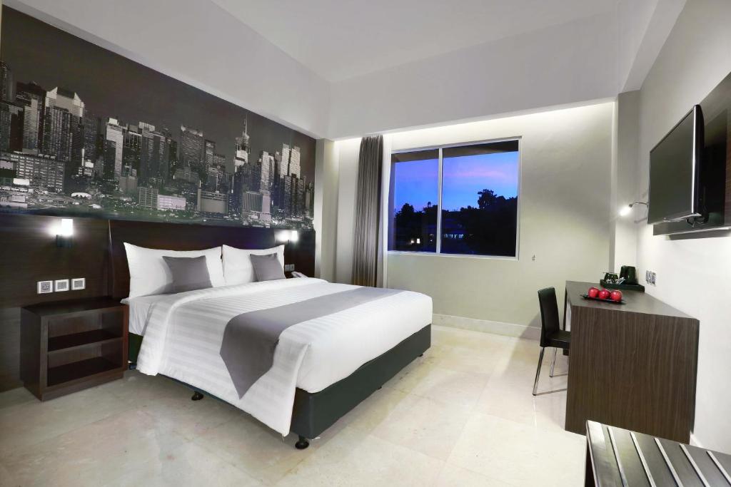 Postel nebo postele na pokoji v ubytování Hotel Neo+ Balikpapan by ASTON