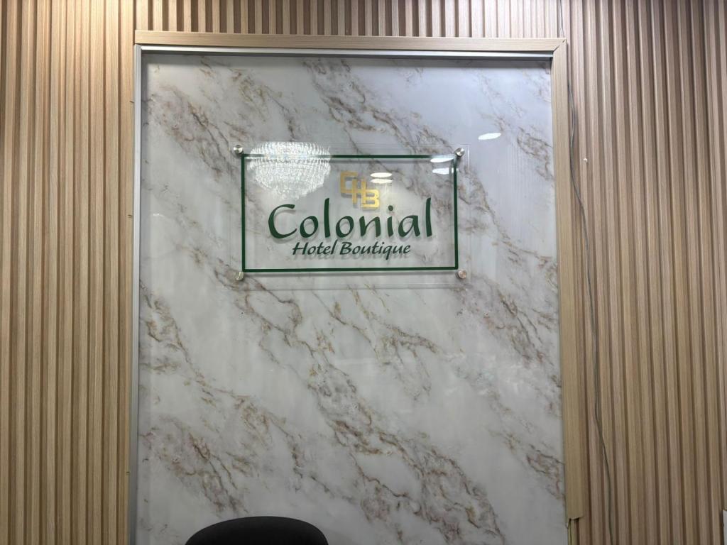 a marble wall with a sign for a colonial hotel boutique at Colonial Hotel Boutique by VBermor in Santo Domingo