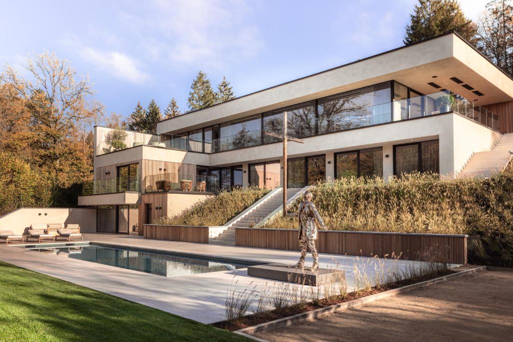 a house with a swimming pool in front of it at Tarida Durbuy in Durbuy