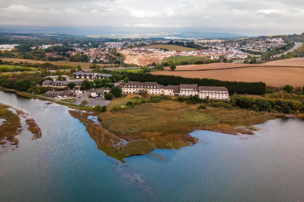 an aerial view of a house on an island in the water at Puffin in Newton Abbot