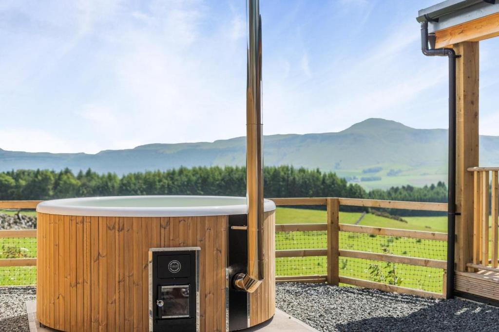 a hot tub on a deck with a view of mountains at 2 Bed in Strathmiglo oc-w32098 in Strathmiglo