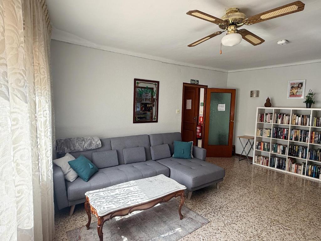 a living room with a couch and a ceiling fan at Ebro Valley Apartment in Móra d'Ebre