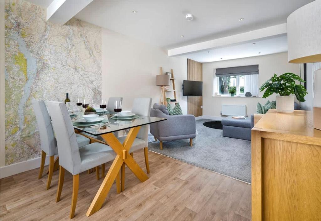 a dining room and living room with a table and chairs at Martindales Yard in Kendal