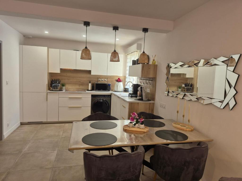 a kitchen with a table and chairs in a room at Chez Isa, Les pieds dans l'eau in Valras-Plage
