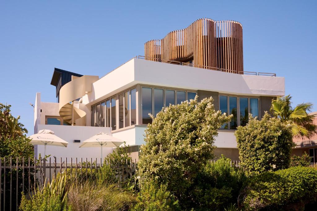 a white building with trees in front of it at ocean10 Guesthouse in Cape Town