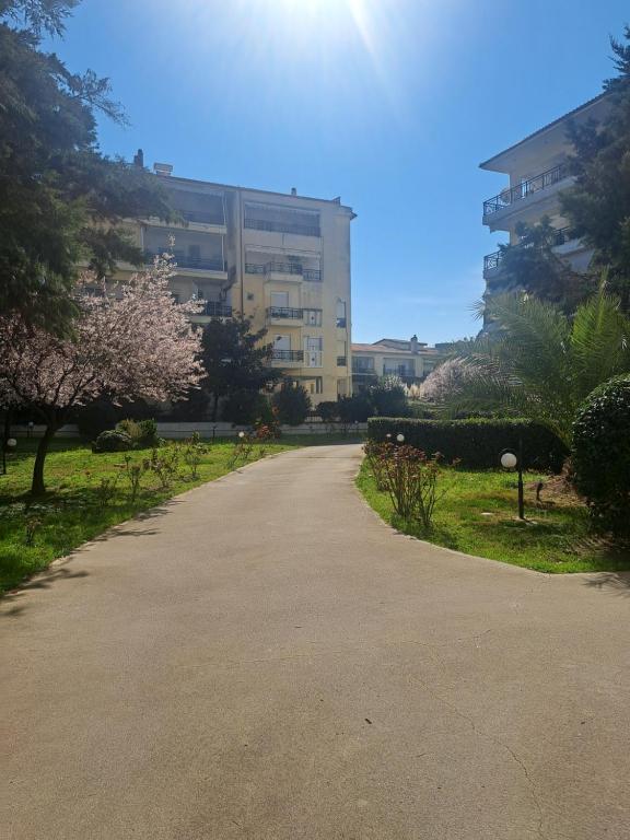 an empty road in front of a building at Nana apartment in Perea