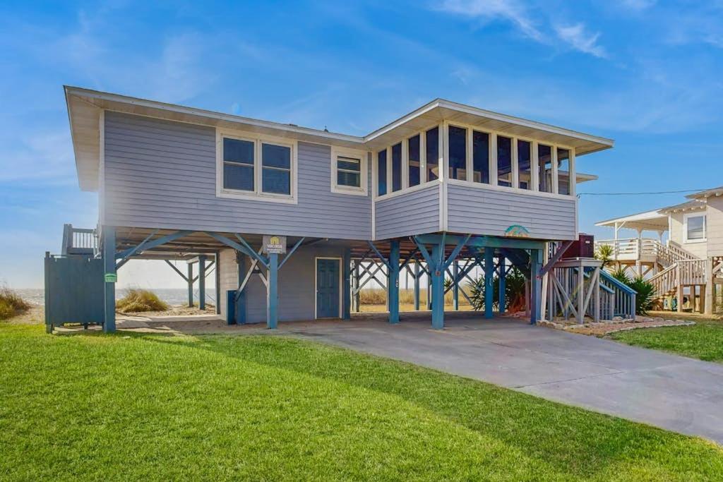 a large house with a porch on a lawn at Sunrise, Sunset in Edisto Beach
