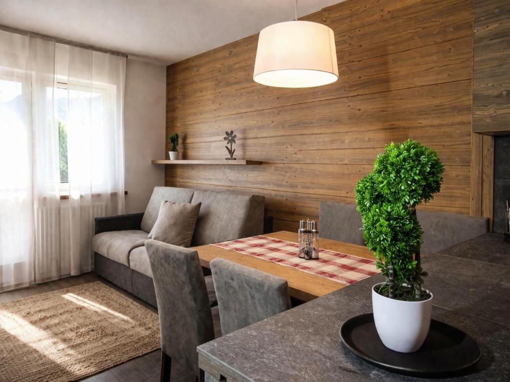 a living room with a table and a couch at CASA IBEX - Residence Veronza con piscina, Dolomiti Affitti in Cavalese