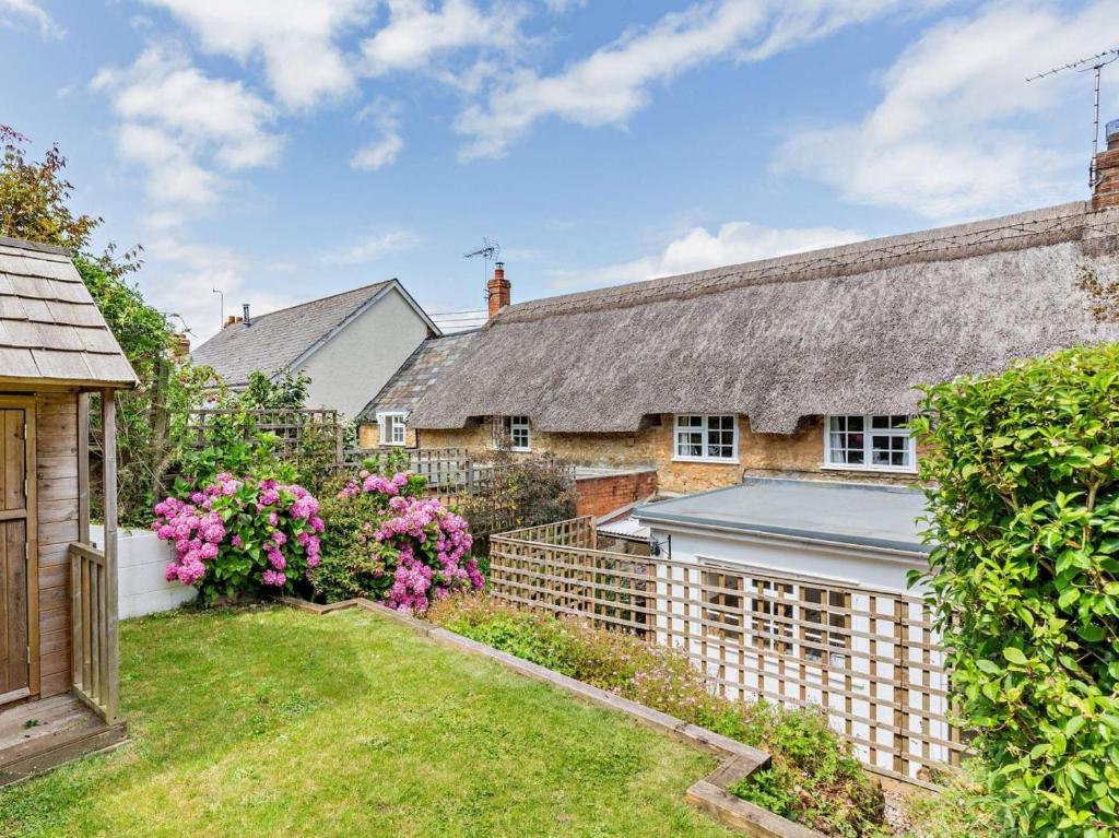 an exterior view of a house with a garden at 2 Bed in Bridport oc-77557 in Loders