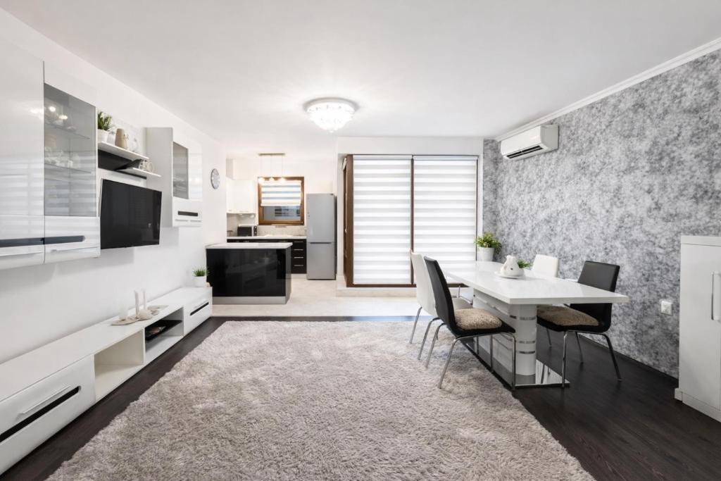 a kitchen and dining room with a table and chairs at Marica Apartment in Plovdiv