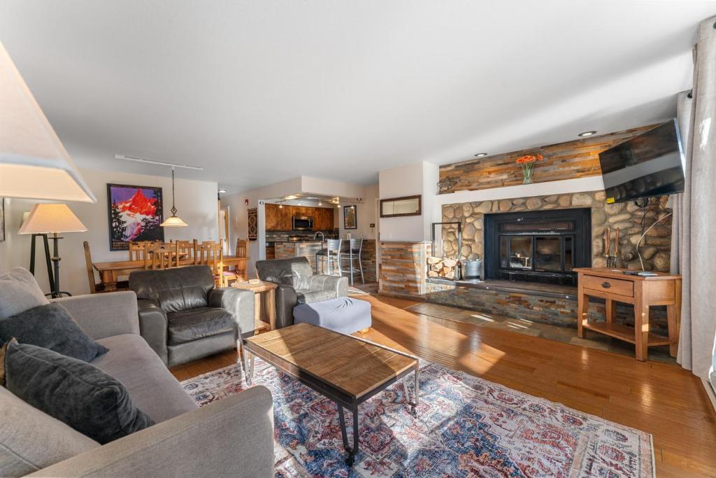 a living room with a couch and a fireplace at Pines #2165 in Keystone