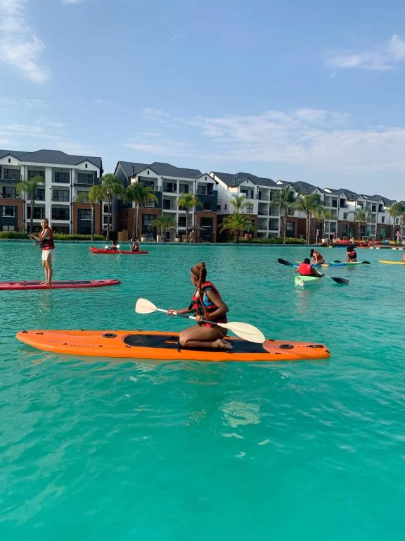 a woman sitting on a kayak in the water at The blyde 1 bedroom in Pretoria