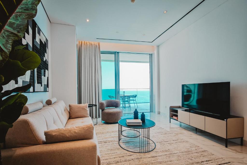 a living room with a couch and a tv at Stunning 1 Bed in Trilogy, Limassol Seafront in Limassol