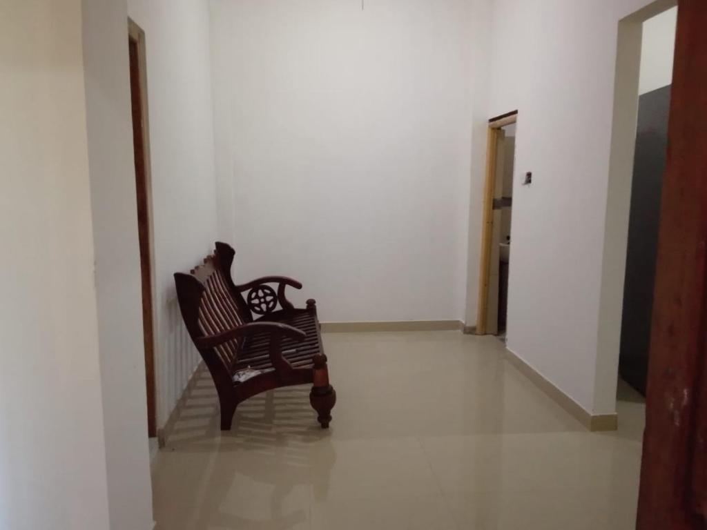 two chairs sitting in a room with a hallway at Tha Ivory villa in Nattarampota