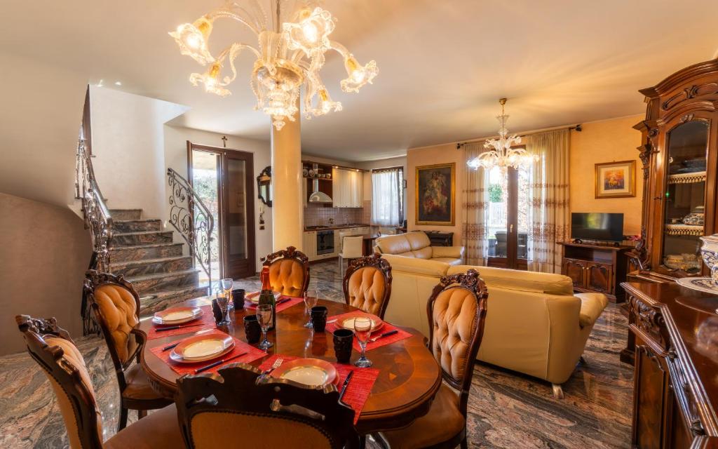 a dining room and living room with a table and chairs at Villa Infinity Garda in Peschiera del Garda