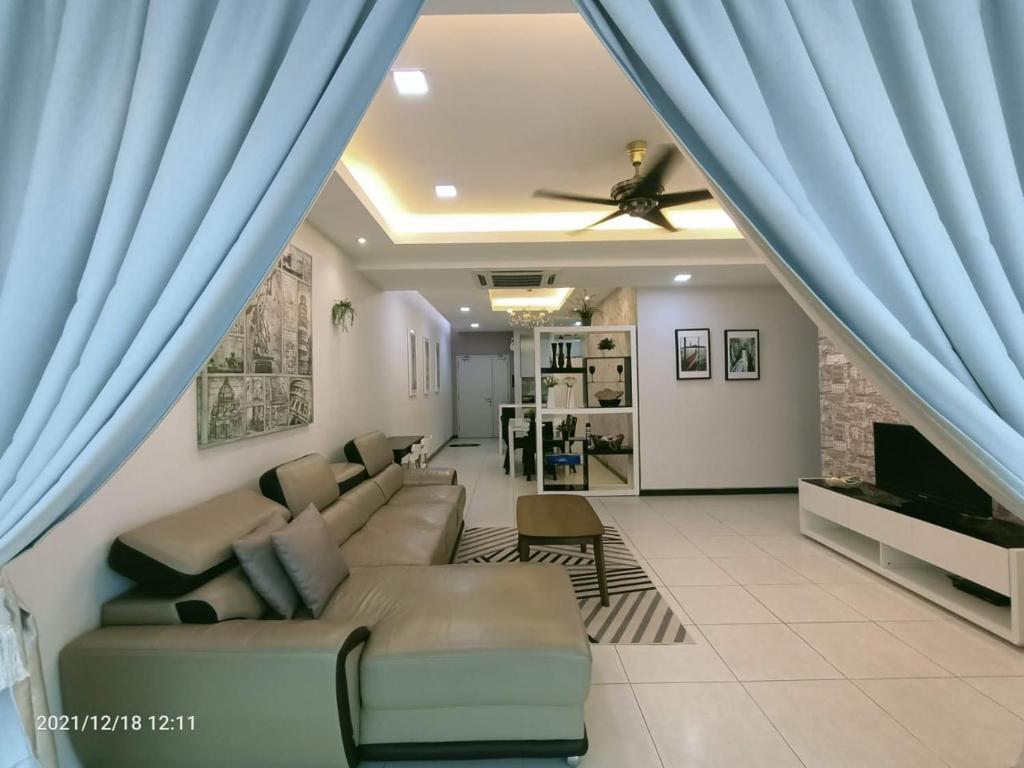 a living room with blue curtains and a couch at Sekinchan Paddy via Seaview Home 高楼 看海 稻田 民宿 in Sekinchan
