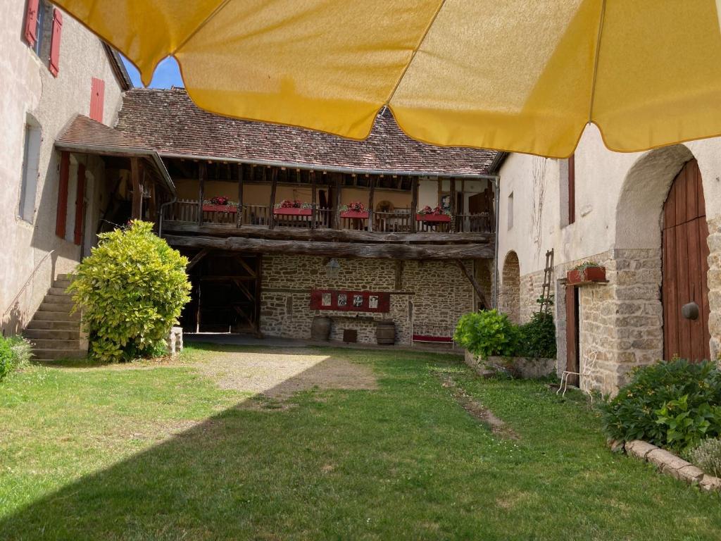 an outside view of a building with a yellow umbrella at B&B Esprit d'un Moment in Nolay