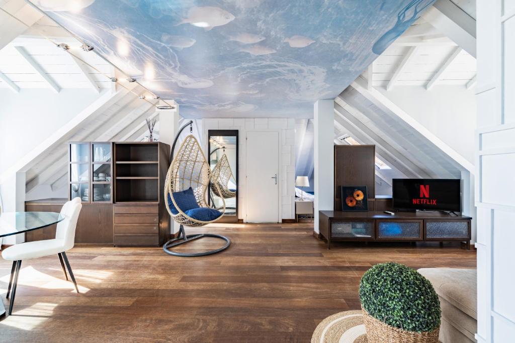 a living room with a blue ceiling with a table and chairs at Alassio White Loft in Alassio
