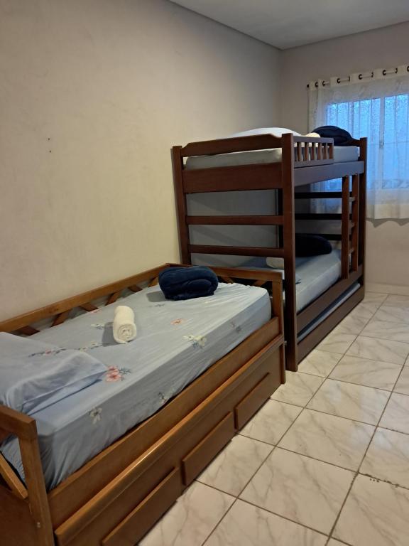 two bunk beds sitting in a room with a tile floor at Kitnet 4 Vila Lunardi in Campinas