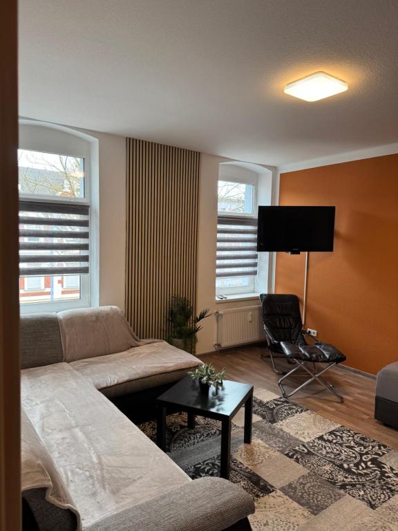 a living room with a couch and a flat screen tv at Ferienwohnung Florion 4 in Bernburg