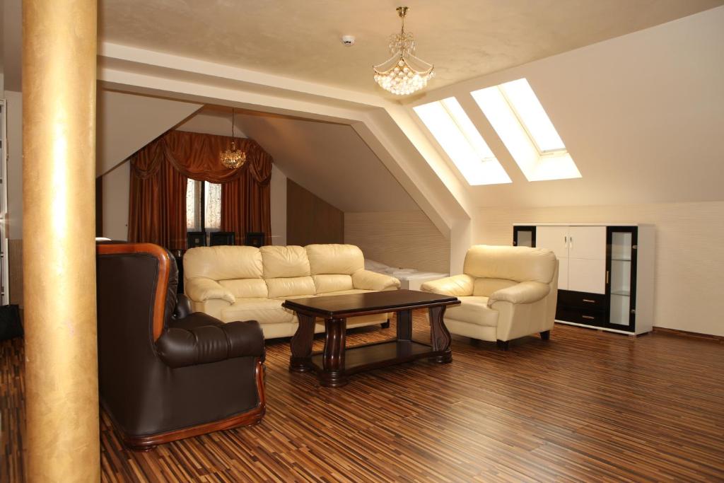 a living room with two chairs and a table at Apartment Kotva in Bratislava