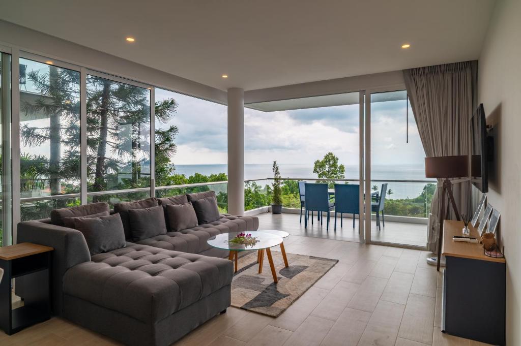 a living room with a couch and a table at The Residence Seaview in Nathon Bay