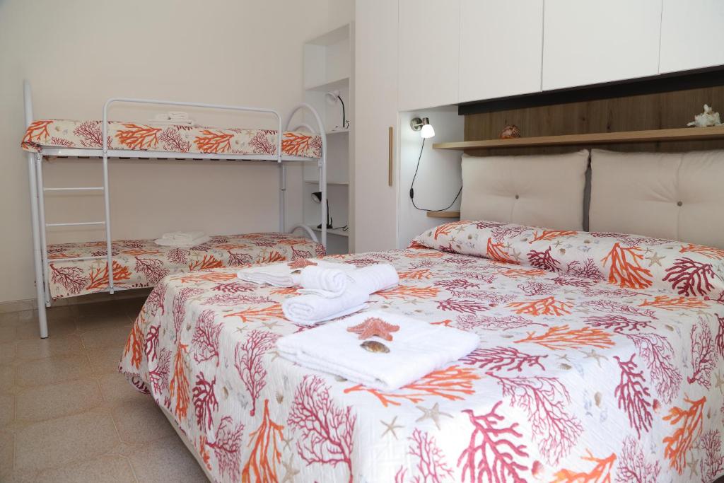 a bedroom with two beds and a bunk bed at Casa Noto in Marettimo