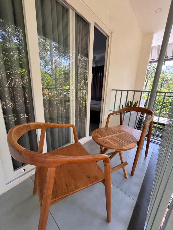 a pair of chairs and a table on a porch at Times Villa in Anachal