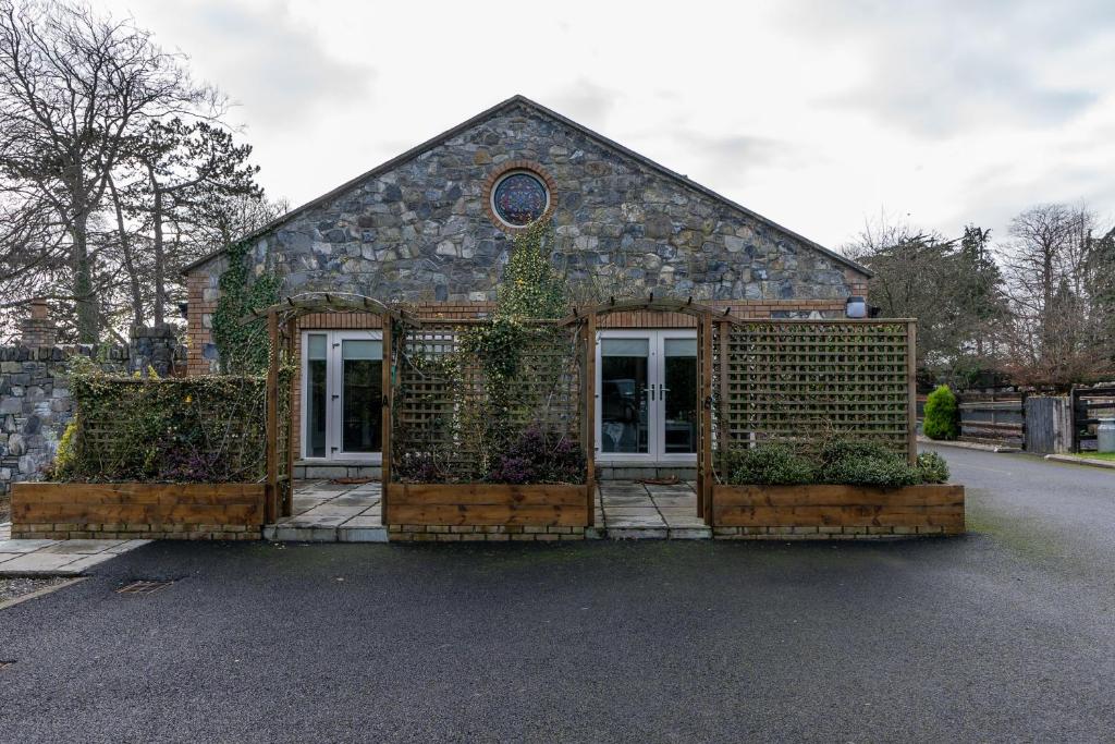 a small stone building with ivy on the front at Alensgrove Maisonette A in Leixlip