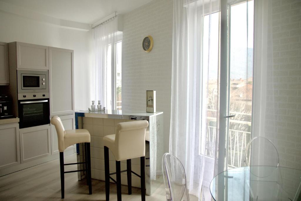 a kitchen with a table and chairs and a window at "Felicita" San Francesco lake view Relax Apartment in Lecco