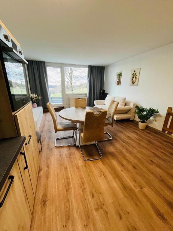 a living room with a table and a couch at Ferienwohnung Nelli in Sankt Englmar