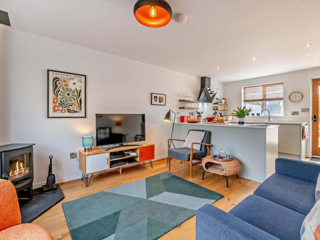 a living room with a blue couch and a fireplace at 2 Bed in Helmsley oc-g0037 in Helmsley