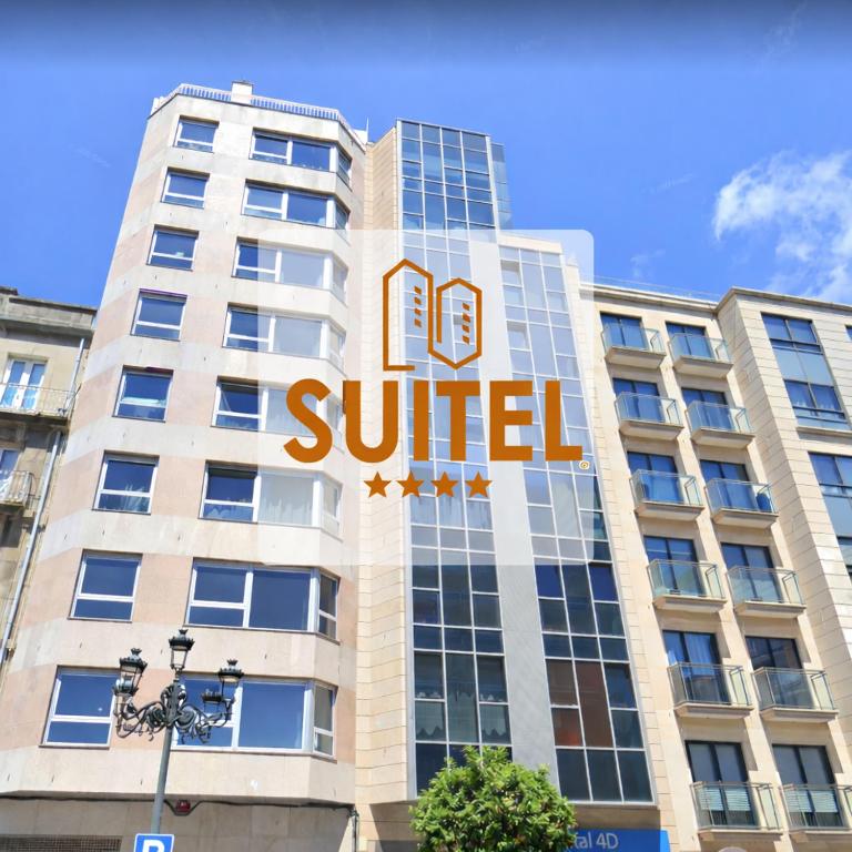 a building with a sign on the side of it at Cíes Premium Suitel García Barbón 73 - Love your Stay in Vigo