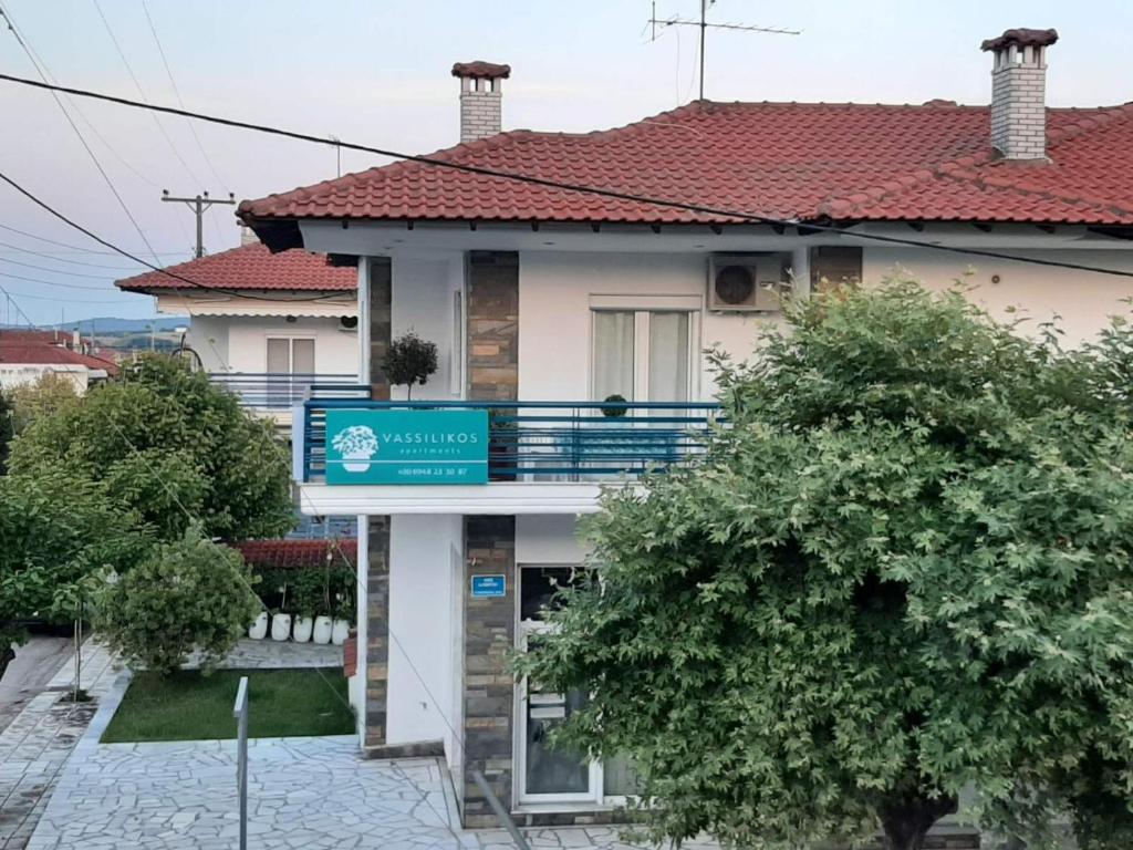 a house with a sign in front of it at Vassilikos Apartment in Flogita