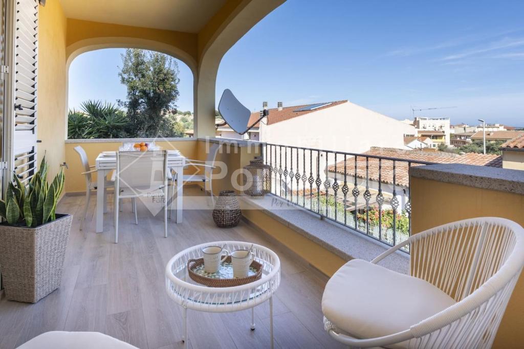 a room with a balcony with a table and chairs at Raphael's Boutique Stay in Palau