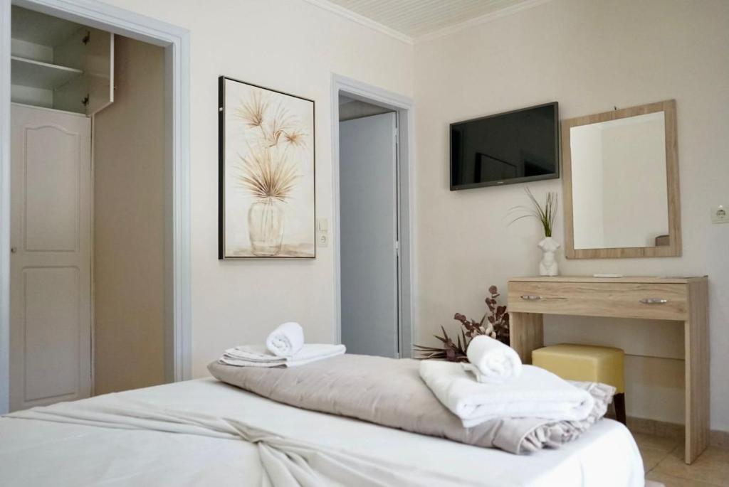 a bedroom with a bed with two towels on it at Pythari Summer House in Laganas