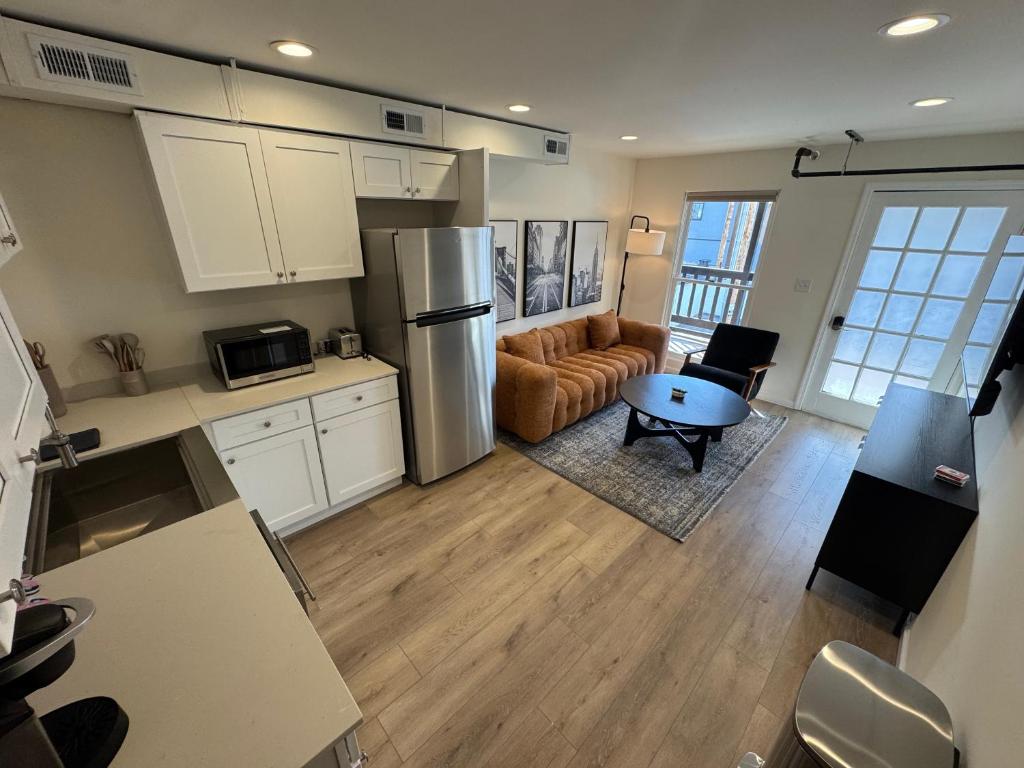 a kitchen and living room with a couch and a table at The Brick & Beam 3rd Floor Apartment in St. Charles