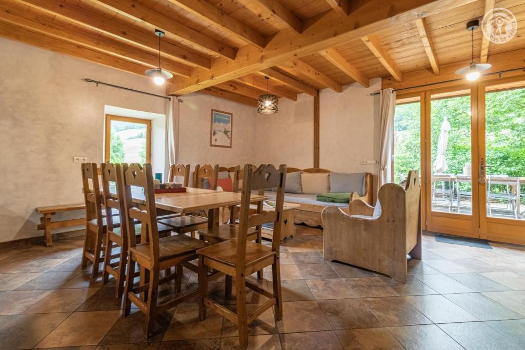 a dining room with a wooden table and chairs at Gites le moulin - rochette in La Compôte