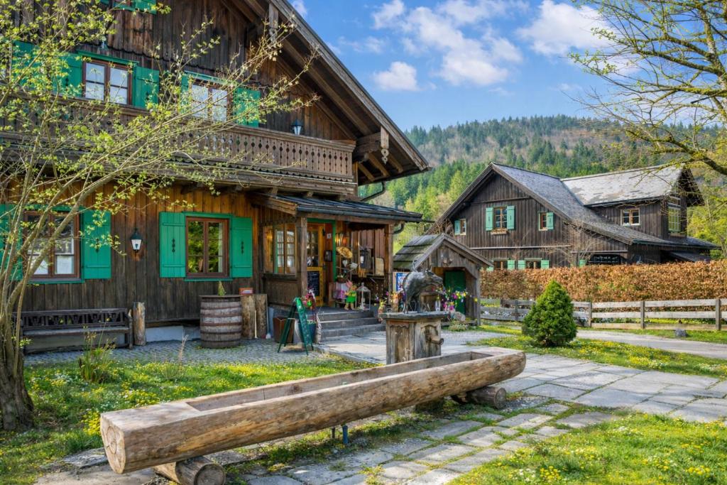 a wooden house with a bench in front of it at Blaa Alm in Altaussee