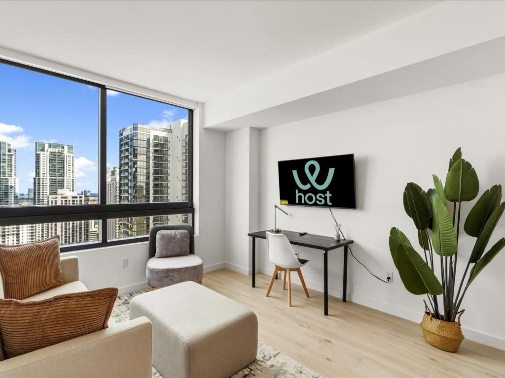 a living room with a desk and a floor to ceiling window at Prime Downtown Miami Location with Rooftop Pool in Miami