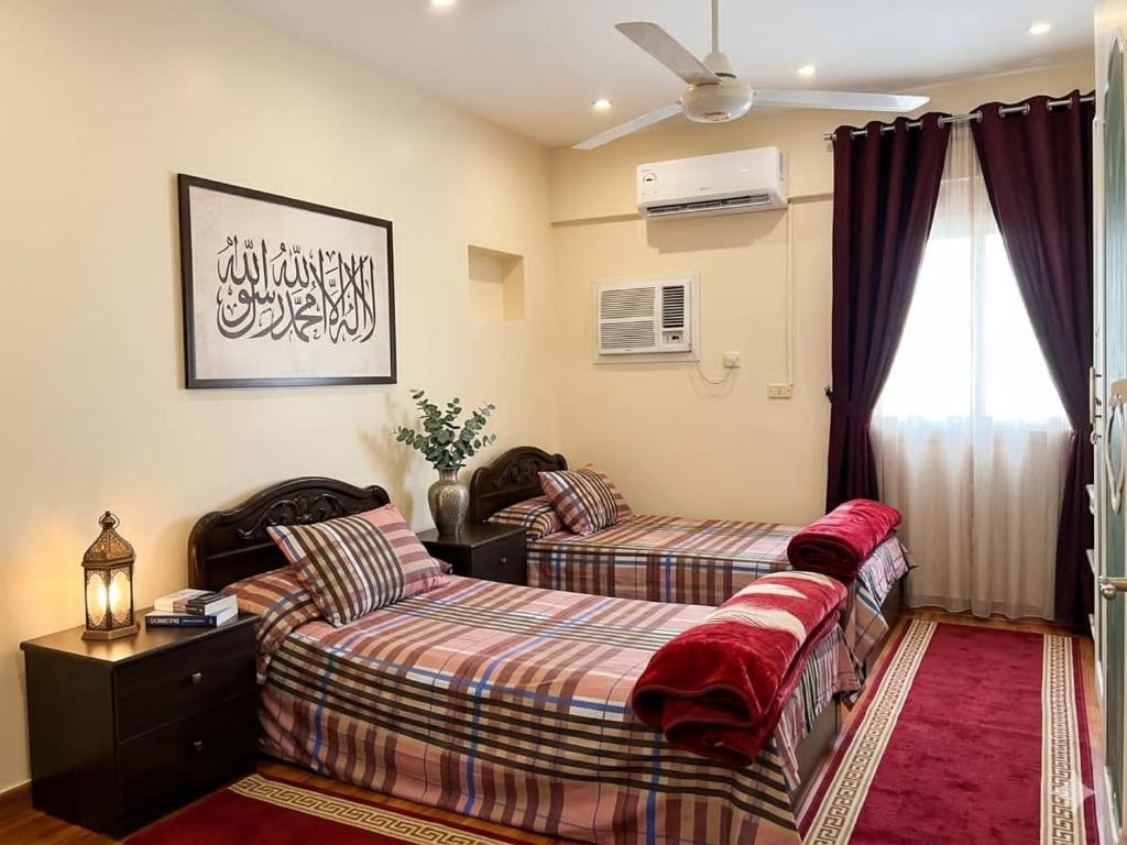 a bedroom with two beds and a window at شقة فاخرة موقع ممتاز in Aswan