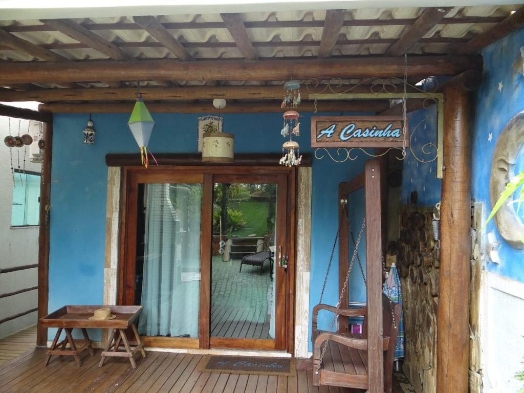 a porch of a house with a glass door at a casinha in Serra Grande