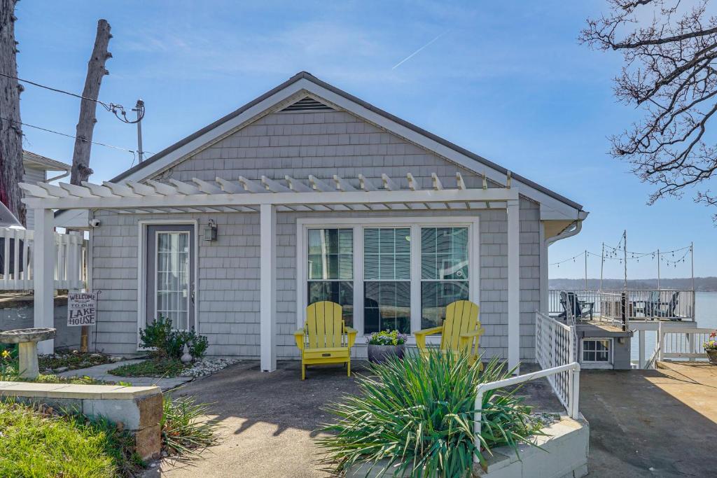 a small house with two yellow chairs on a patio at ‘Cliff View Haven’ | Million-Dollar Views at 6MM in Rocky Mount