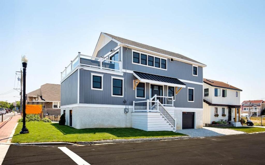 a gray house with a staircase in front of a street at The Anchorage Cape May in Cape May