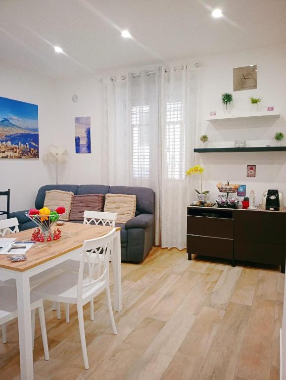 a living room with a table and a couch at Trieste Apartment in Reggio di Calabria