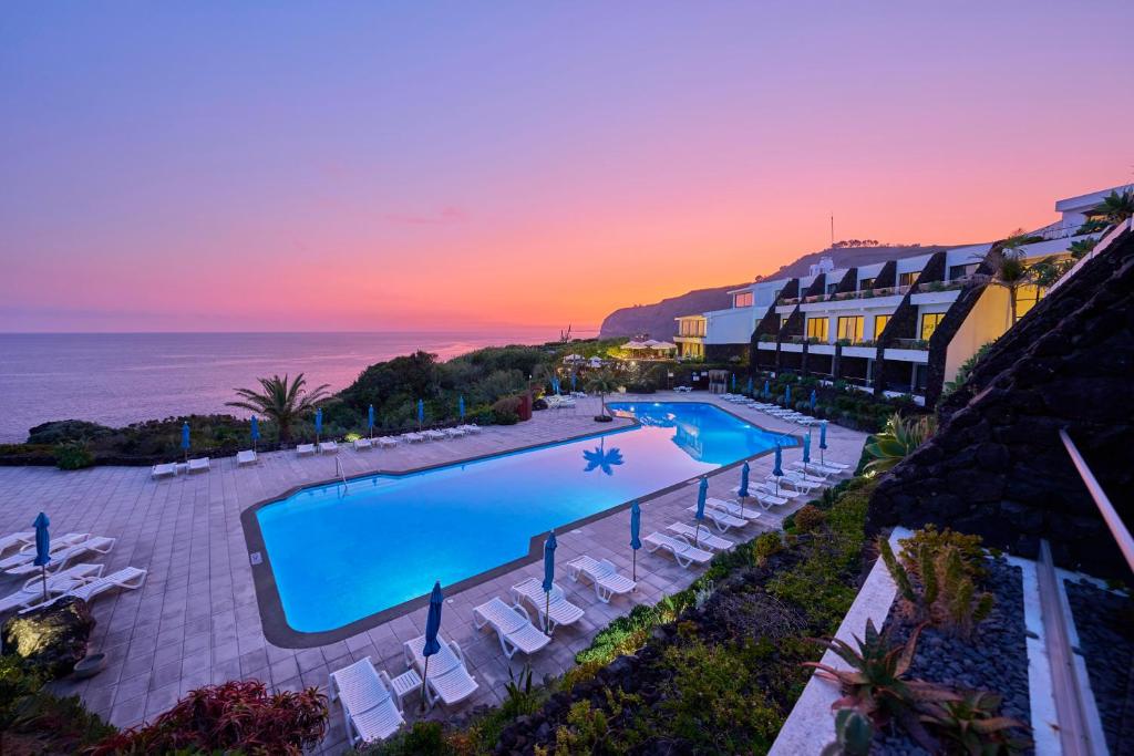 an aerial view of a resort with a swimming pool at Caloura Hotel Resort in Caloura