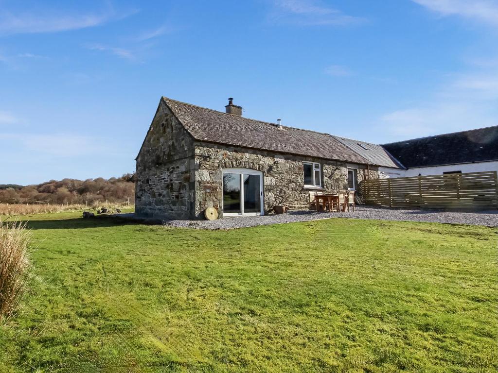 an old stone cottage with a large grass yard at Coelard The Barn - Uk50538 in Appin