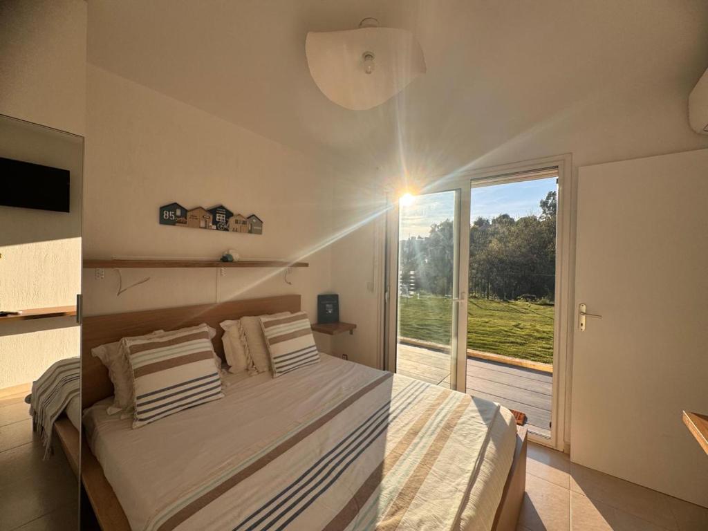 a bedroom with a bed and a large window at Villa Horizon in Nice
