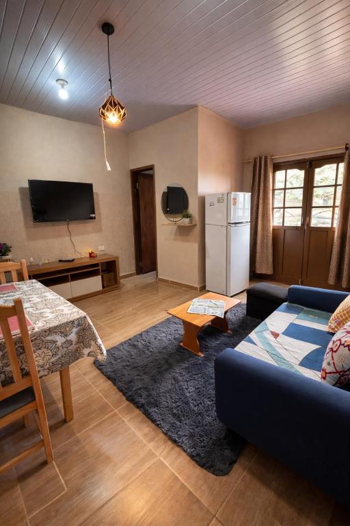 a living room with a blue couch and a refrigerator at Confort moderno, cerca de todo in Fernando de la Mora