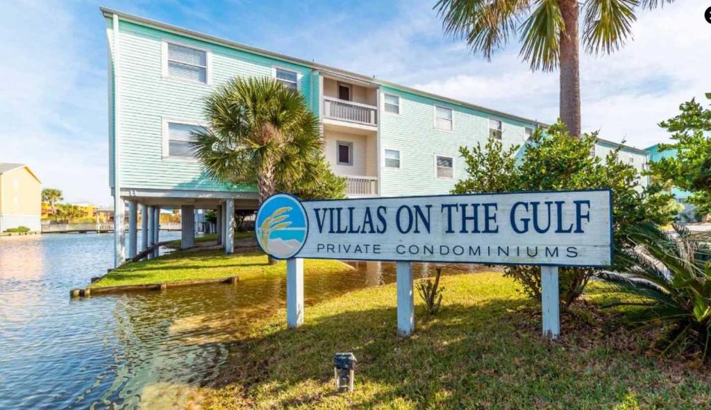 a villas on the gulf sign in front of a building at Vibrant gulf condo with pool and beach access in Pensacola Beach